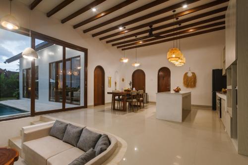 a living room with a couch and a table at Villa Shekinah Oasis in Ubud
