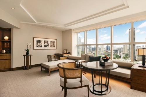a living room with a couch and a table at Conrad Singapore Marina Bay in Singapore