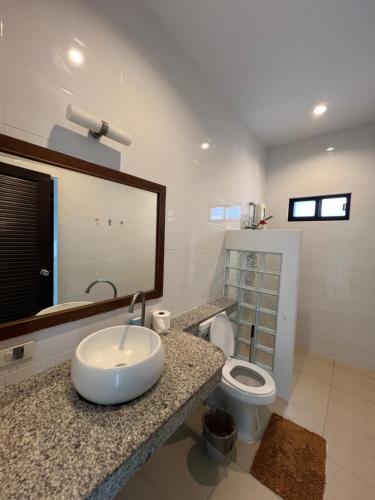 a bathroom with a sink and a toilet at Nern Khao Guest House in Kamala Beach