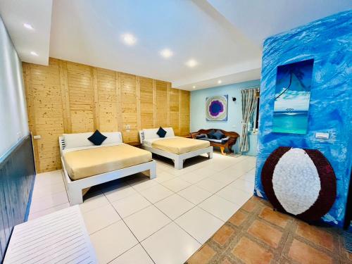 a living room with two beds and a couch at Hai Yuan Bungalow II in Kenting