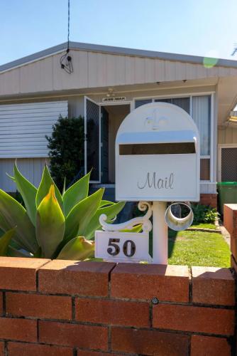 a mailbox on a brick wall in front of a house at The Golden Beach Residence in Golden Beach