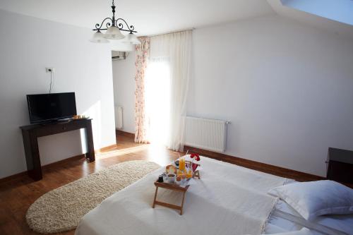 a bedroom with a bed with a toy on it at Pension Perla Bucovinei in Voronet