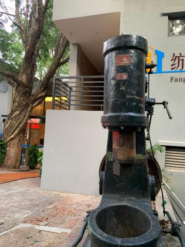 a black machine sitting in front of a building at Guangzhou Fangyuan Hotel - Free Shuttle Bus to Canton Fair Complex during 14th Oct to 3rd Nov in Guangzhou