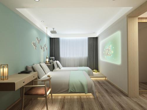 a bedroom with a large bed and a desk at Happy Dragon Universal Vacation Hotel - close to Universal Studio and Wanda Plaza,free shuttle to the Resort,Free Coffee,Laundry in Beijing