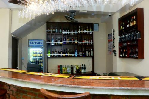 a bar with a lot of bottles of alcohol at Sea Shine Beach Hotel in Uswetakeiyawa