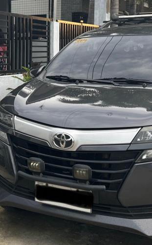 a front view of a car parked in a parking lot at Avanza in Hinigaran