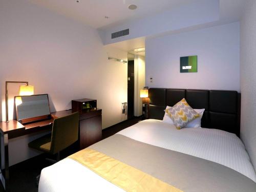 Postel nebo postele na pokoji v ubytování Hotel Gracery Tokyo Tamachi