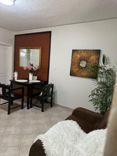 a living room with a table and a dining room at Modern and Cozy Loft in La Ceiba