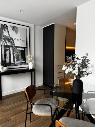 a living room with a glass table and chairs at Brunswick Apartment with Car Park in Melbourne