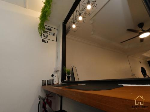 a room with a desk with a sign on the wall at Lyd's Home Urban Staycation in Sibu