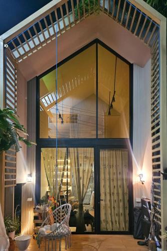 a room with a large glass door with a balcony at hiddenmoon cottage in Bangkok