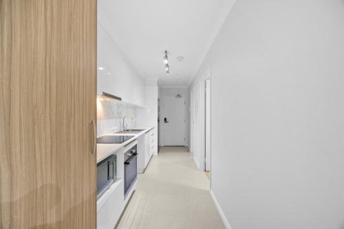 a kitchen with white counters and a long hallway at Sun Sand & Style Cozy 2BR Coastal Retreat in Rockingham in Rockingham