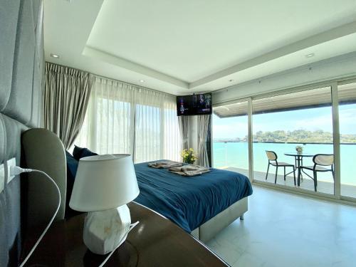 a bedroom with a bed and a view of the ocean at Seaview Duplex Home - Panwa Beach - Baan Jayden in Phuket Town