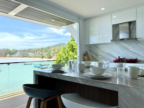 a kitchen with a counter with a view of the water at Seaview Duplex Home - Panwa Beach - Baan Jayden in Phuket