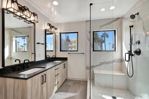 a bathroom with a shower and two sinks and a shower stall at South Beach Living #1 in Imperial Beach
