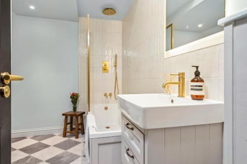 Un baño blanco con lavabo y ducha. en Beachside Maisonette Southbourne, en Bournemouth