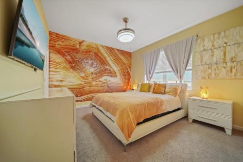a bedroom with a bed and a painting on the wall at The Bling Estate in Kissimmee