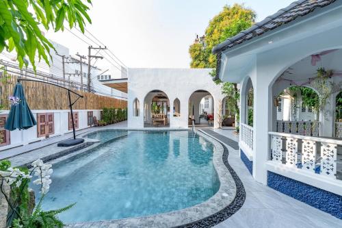 a swimming pool in the courtyard of a house at Baan Nai Chiang Mai Retreat House Private Pool in Chiang Mai