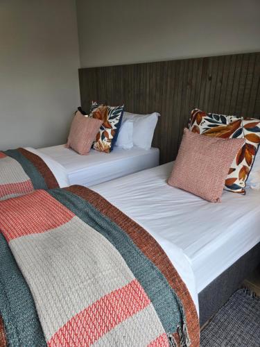 two beds sitting next to each other in a room at Fifty Ridge in George