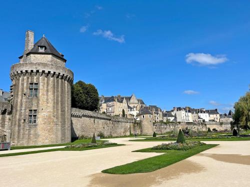 an old castle with a city in the background at Le clos du ponant in Ploeren