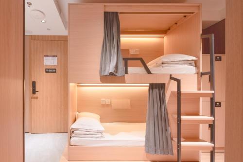 a room with bunk beds in it at Dayin Garden Hotel -People's Square & Nanjing Road-Large Social Area -Bar -Café -Gym -Free Laundry Luggage Storage -24H Front Desk-English Service in Shanghai