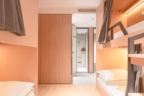a bedroom with orange walls and wooden shelves at Dayin Garden Hotel -People's Square & Nanjing Road-Large Social Area -Bar -Café -Gym -Free Laundry Luggage Storage -24H Front Desk-English Service in Shanghai