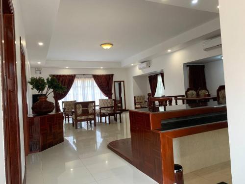 a living room with a table and a dining room at Hawaii Beach Bungalows in Sihanoukville