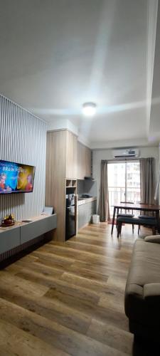 a living room with a couch and a table at Classy! 2BR Apartment - Modern Comfort in West Jakarta CBD in Jakarta