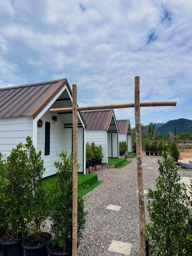 a wooden cross in front of a white building at Lantamangrove in Ban Ru Yai