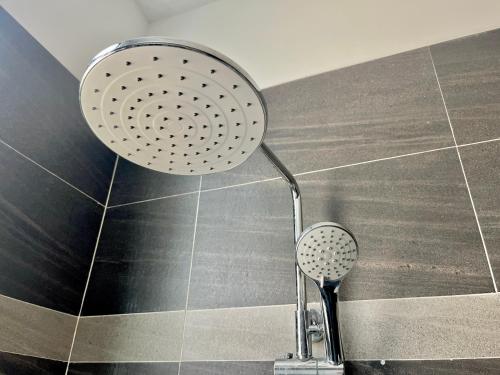 a shower in a bathroom with a shower head at La Mansion Durian Hotel in Kampot