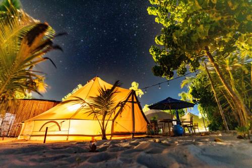a tent on the beach under a starry sky at The MAVERICK SURF AND DIVE BOUTIQUE HOTEL - Book 10 Nights and get 1 Free Night - Free Speed Boat Service - Kids Stay Free in Laamu