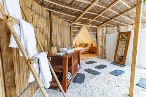 a bathroom with a desk in a bamboo room at The MAVERICK SURF AND DIVE BOUTIQUE HOTEL - Book 10 Nights and get 1 Free Night - Free Speed Boat Service - Kids Stay Free in Laamu