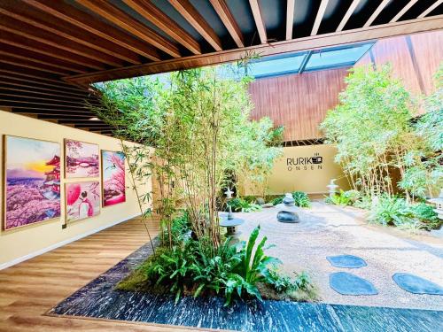 a garden in the middle of a building with paintings at Flamingo1 Ibiza Hai Tien in Nam Khê