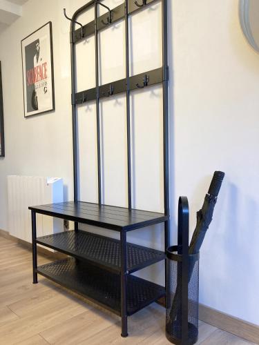 a black table in a room next to a wall at Maison entière avec espace cinéma in Riom