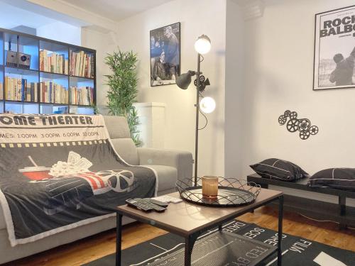 a living room with a couch and a coffee table at Maison entière avec espace cinéma in Riom