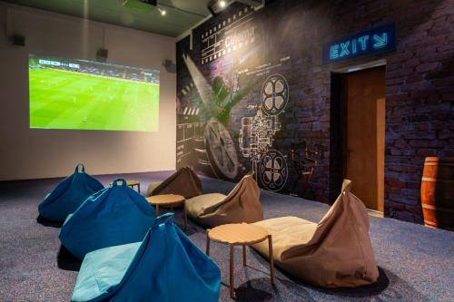 a room with four chairs and a projection screen at Ocean's Creek Beach Hotel in Balaclava