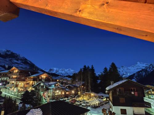 a view of a town in the mountains at night at Santa San in Champoluc