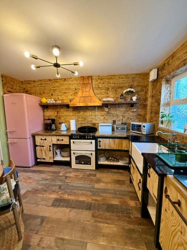 a large kitchen with wooden walls and a refrigerator at Superb Large Bespoke 5 Star Detached Villa, Prime Location, Belfast Stay in Belfast