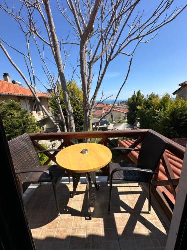 a wooden table and chairs on a balcony with a table at Villa Makri in Makri