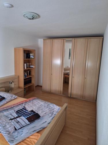 a bedroom with a bed and wooden wardrobes at Ferienwohnung am Koptischem Kloster in Höxter