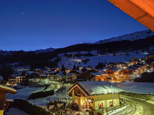 a small town in the snow at night at Santa San in Champoluc