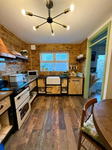 a kitchen with wooden floors and a ceiling fan at Superb Large Bespoke 5 Star Detached Villa, Prime Location, Belfast Stay in Belfast