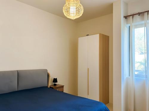 a bedroom with a bed and a cabinet and a window at Waterway Residence Apartment C2 groundfloor in Cascavelle
