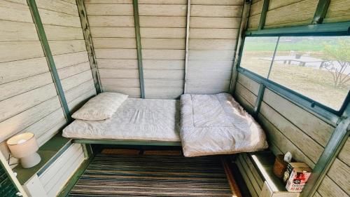 a small room with a bed and a window at ComeOn Stay&Sleep in Chiang Rai