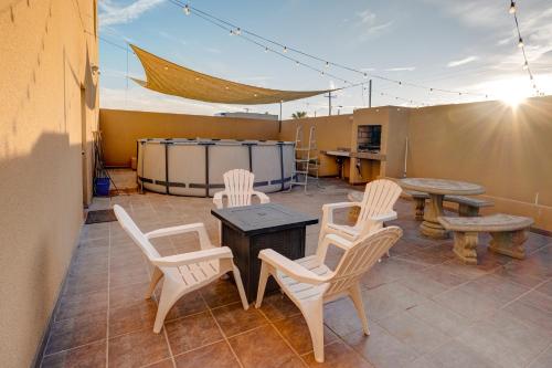 a patio with white chairs and a table and a table at CASA DEL MAR-- Sleeps 16, Pool, AC, Wi-Fi, Near Malecón in San Felipe