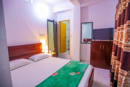 a bedroom with a large bed and a television at Hotel Muna International Residential 6th floor in Dhaka