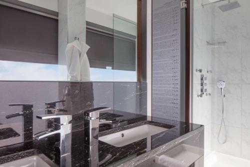 a bathroom with a sink and a shower at Doubletree By Hilton London - Greenwich in London