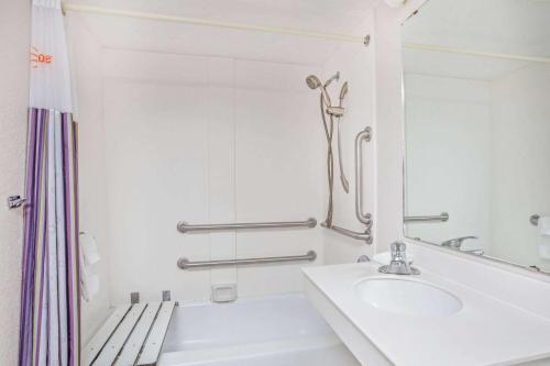a white bathroom with a sink and a shower at La Quinta Inn by Wyndham Reno in Reno