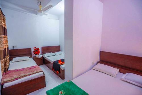 a bedroom with two beds in a room at Hotel Muna International Residential 6th floor in Dhaka