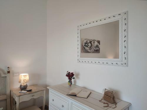 a white room with a mirror and a desk at Don Vittorio Country Village in Taormina